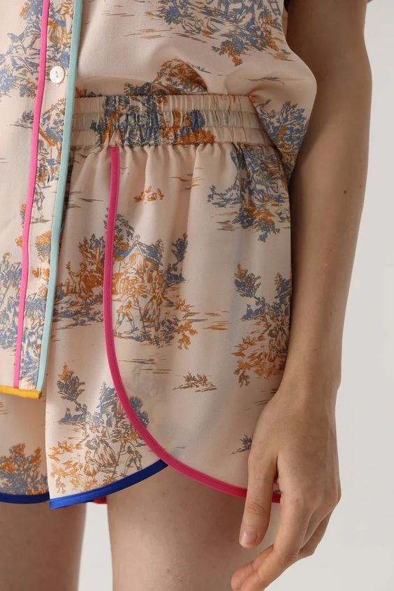 textile embellishment piping paspeln: detail of a printed pj with coloured piping via WGSN